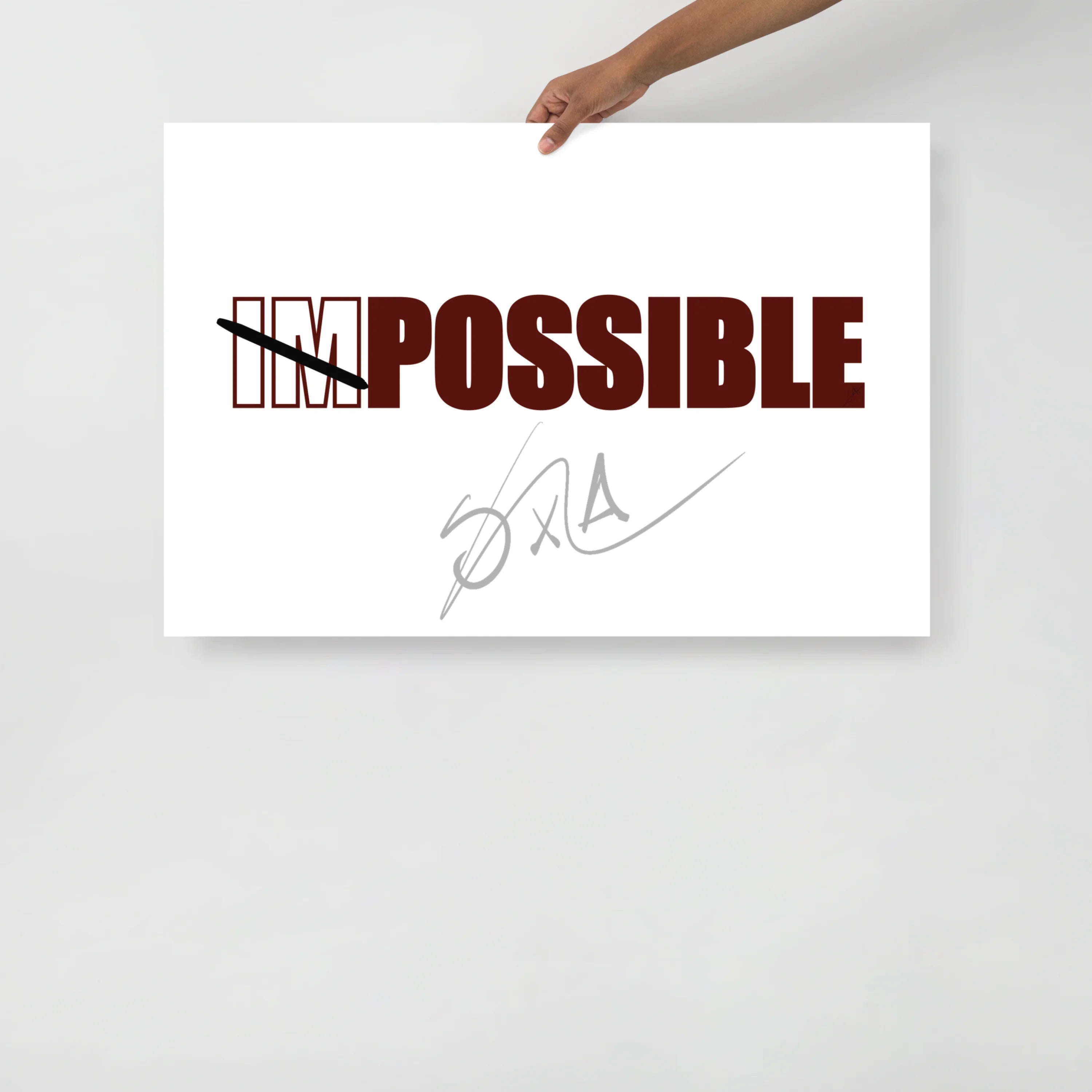 wall art of the text "impossible" with im crossed out